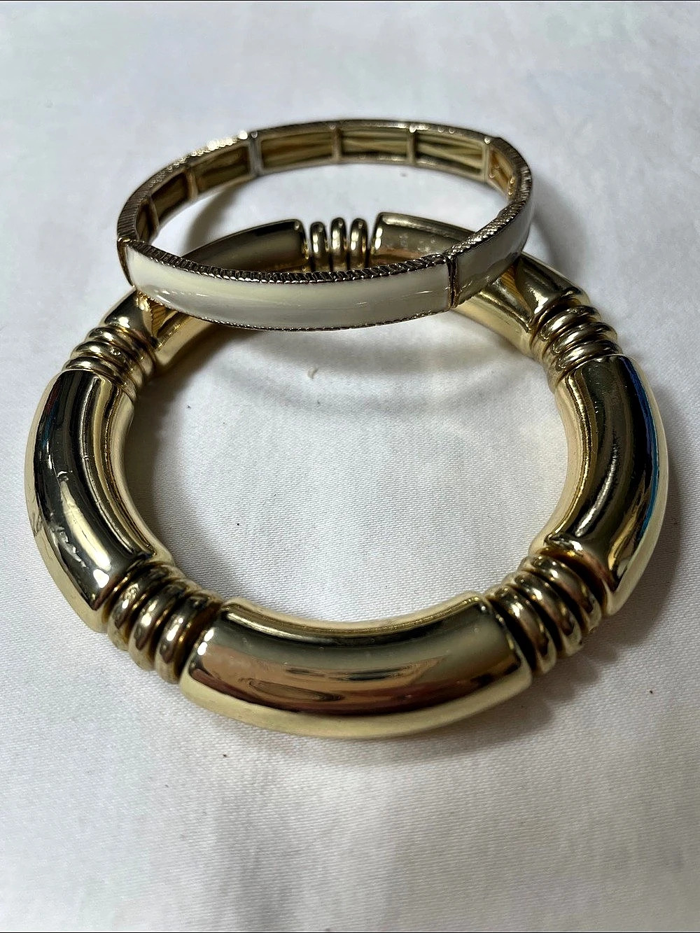 Gold tone stretch bracelet and Gold With Cream Enamel Stretch bracelet Both Brac